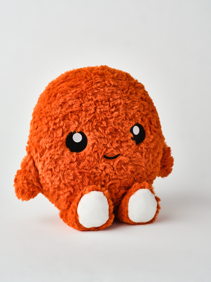 Cute round plush toy with orange fuzzy fur, white feet, and a smiling face on a plain white background facing slightly right