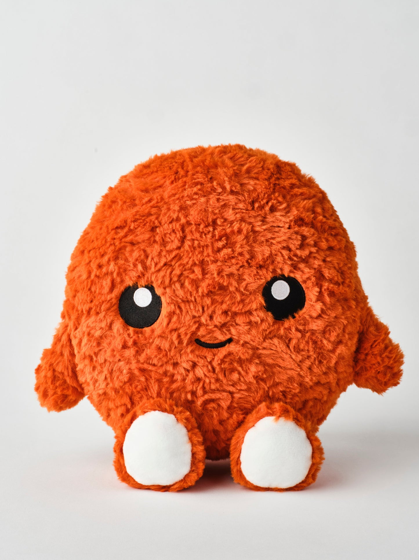 Spicy chicken nugget plush toy with vibrant orange fuzzy texture, round cuddly shape, embroidered face, and soft white feet — perfect for kids, collectors, and novelty gift lovers